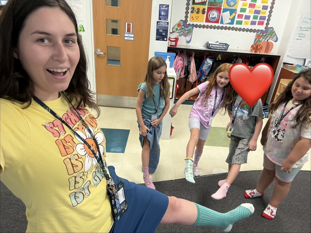 Ms Thompson and students showing off their socks.
