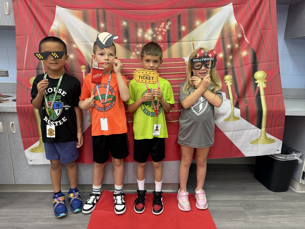 S.T.A.R. Gator Students pose in a room with a red carpet backdrop.