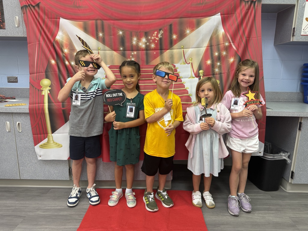 S.T.A.R. Gator Students pose in a room with a red carpet backdrop.