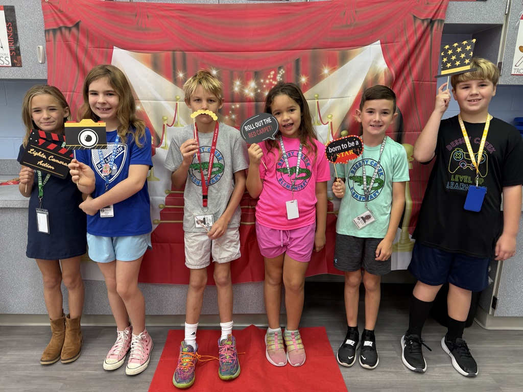 S.T.A.R. Gator Students pose in a room with a red carpet backdrop.