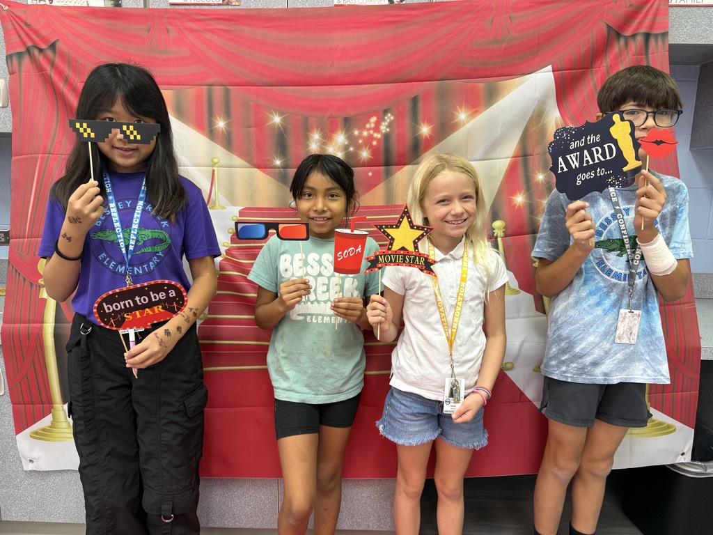 S.T.A.R. Gator Students pose in a room with a red carpet backdrop.