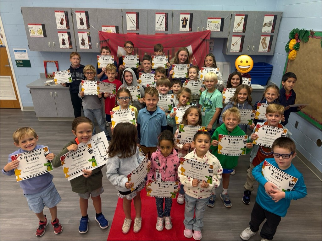 S.T.A.R. Gator Students pose in a room with a red carpet backdrop.