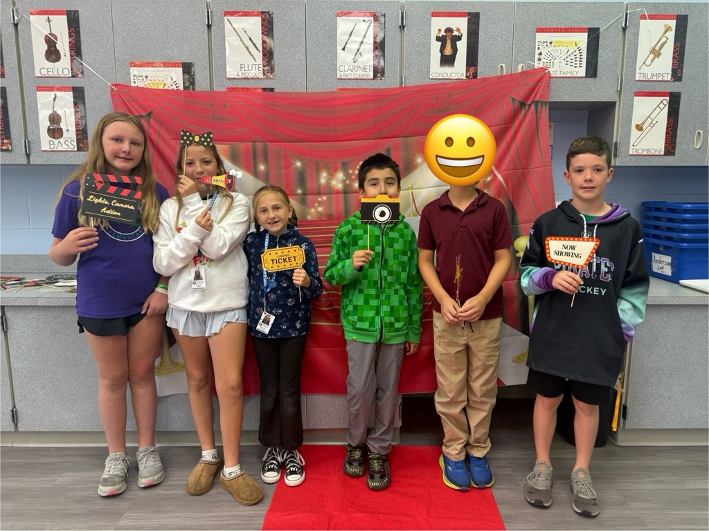 S.T.A.R. Gator Students pose in a room with a red carpet backdrop.
