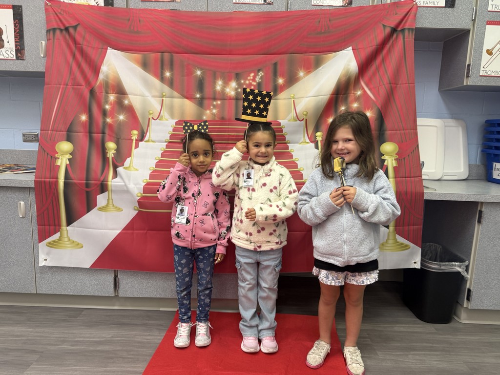 S.T.A.R. Gator Students pose in a room with a red carpet backdrop.