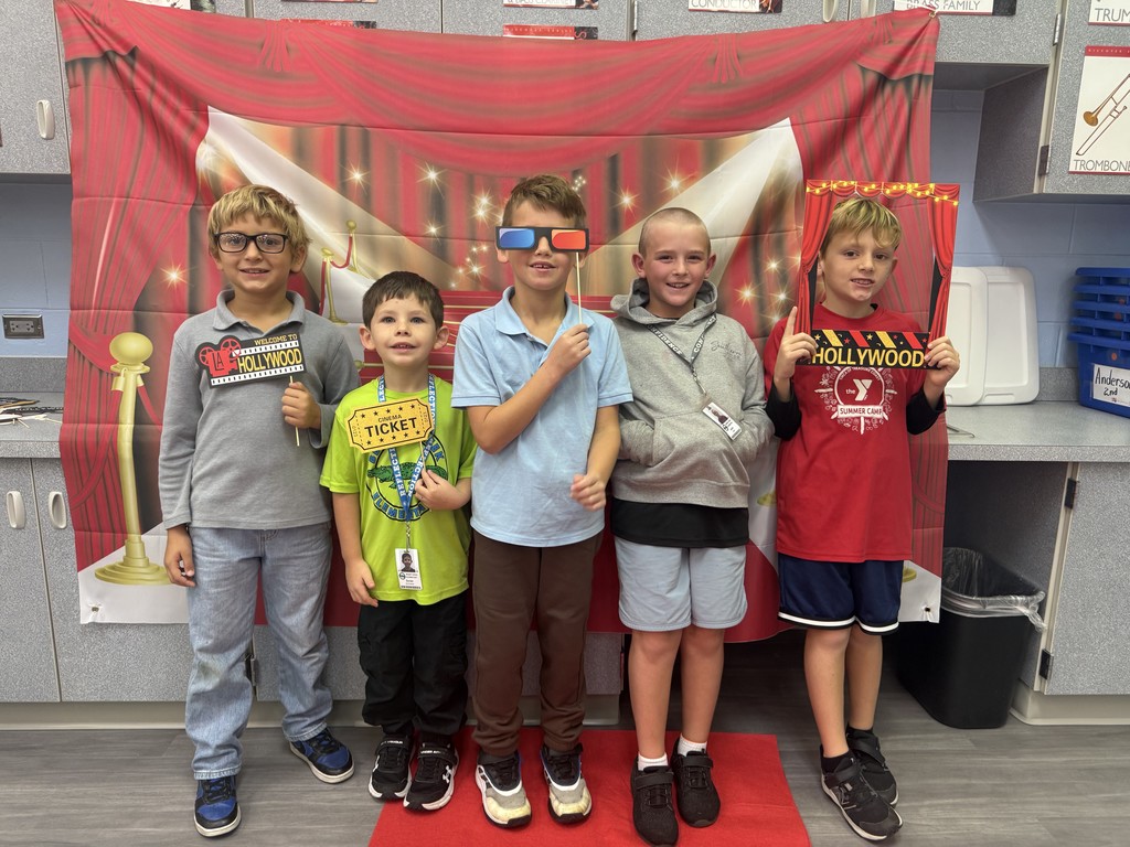 S.T.A.R. Gator Students pose in a room with a red carpet backdrop.