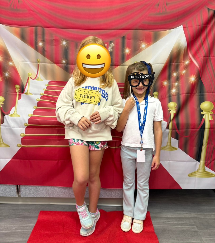 S.T.A.R. Gator Students pose in a room with a red carpet backdrop.