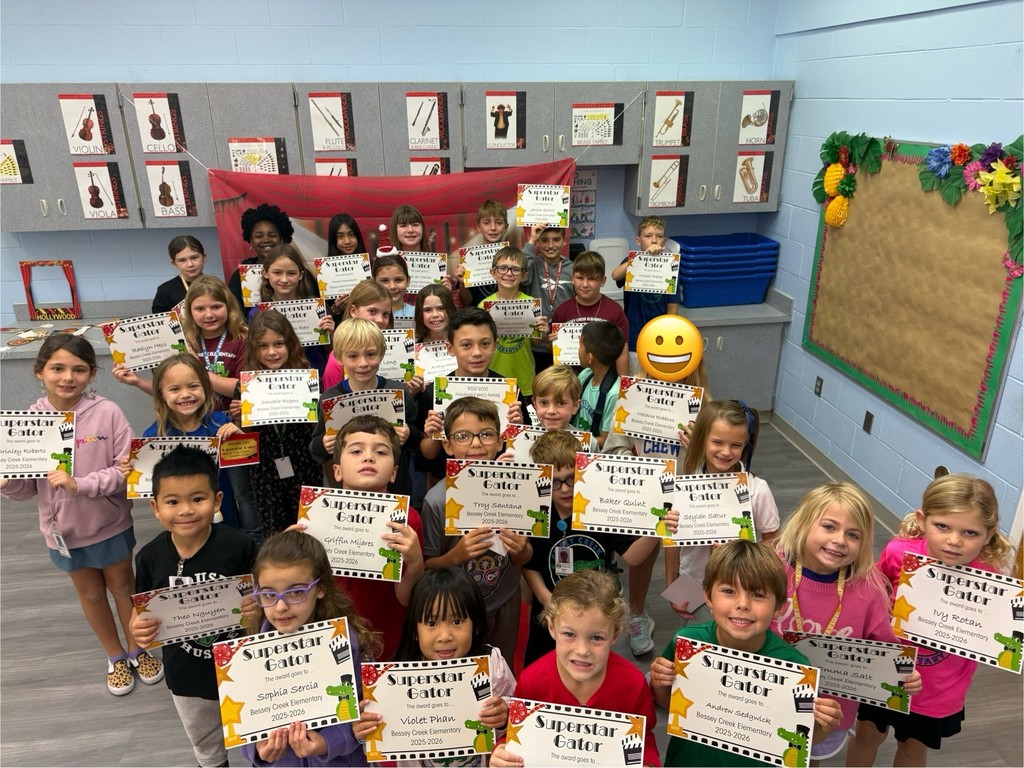 S.T.A.R. Gator Students pose in a room with a red carpet backdrop.