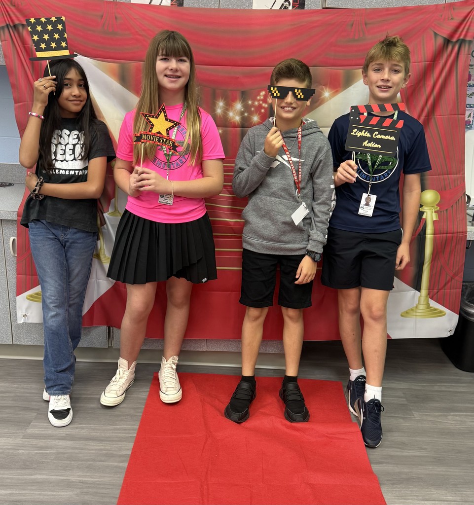 S.T.A.R. Gator Students pose in a room with a red carpet backdrop.