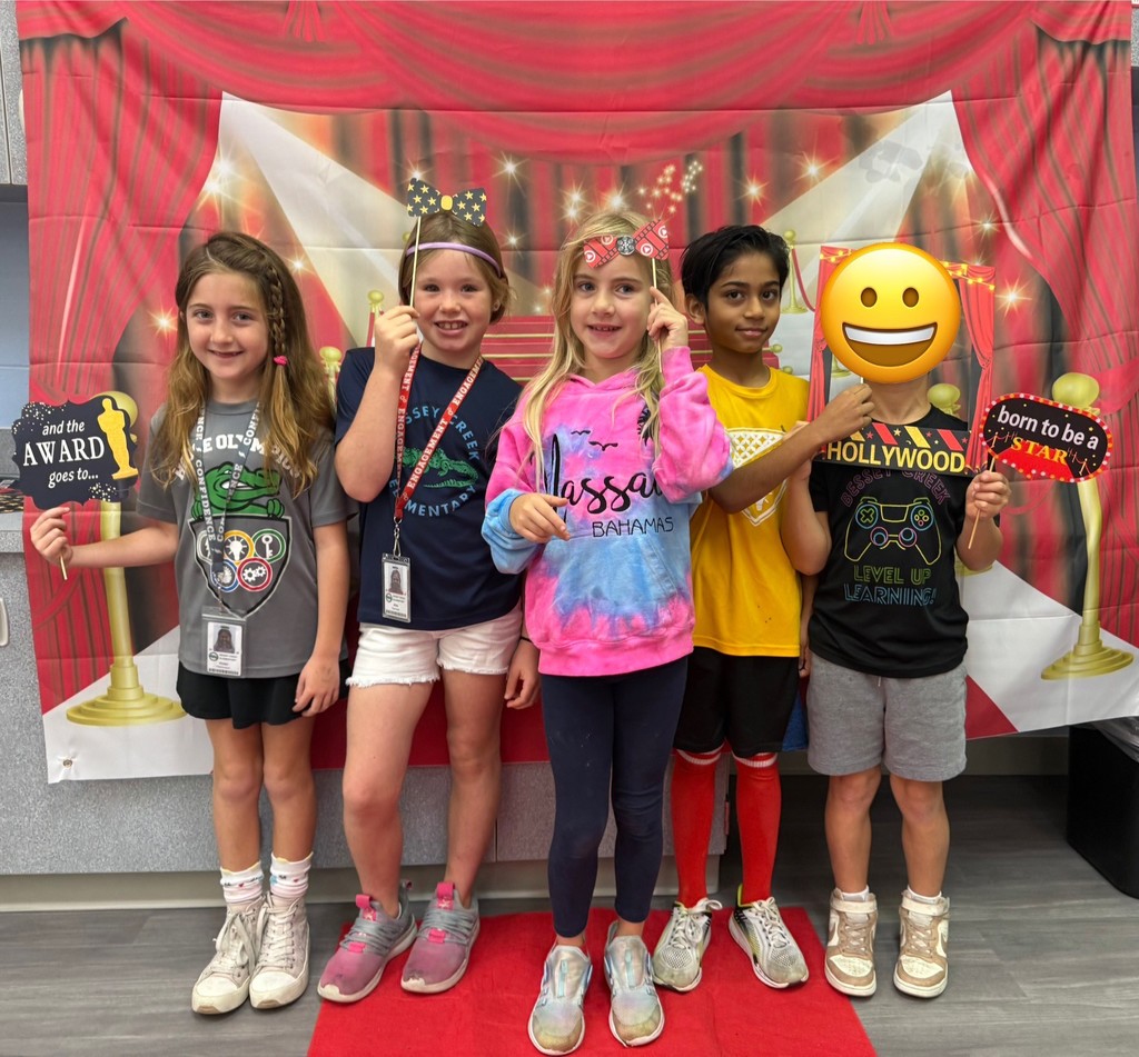 S.T.A.R. Gator Students pose in a room with a red carpet backdrop.