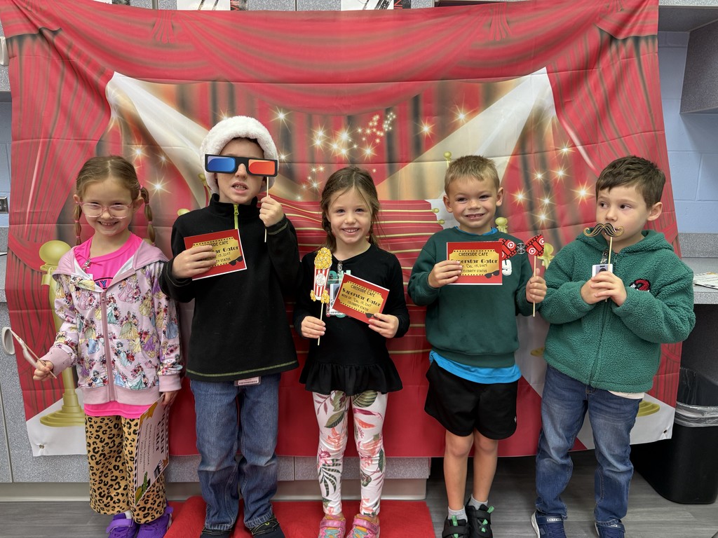 S.T.A.R. Gator Students pose in a room with a red carpet backdrop.