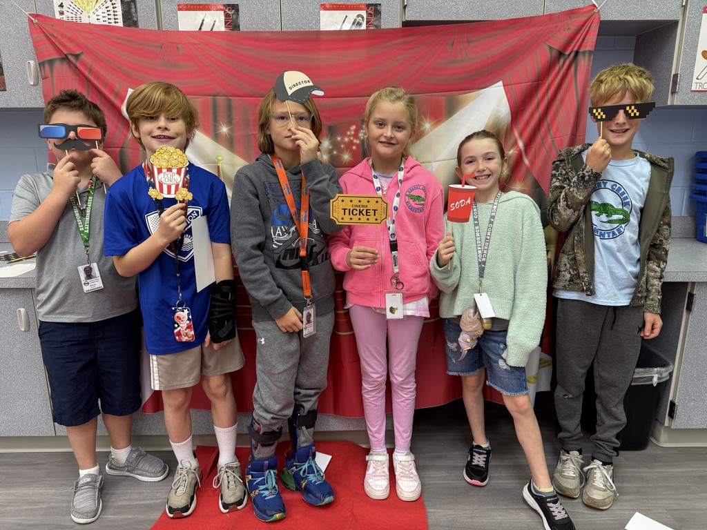S.T.A.R. Gator Students pose in a room with a red carpet backdrop.