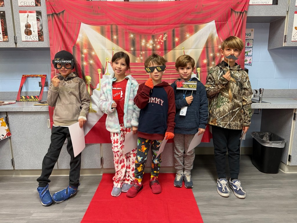 S.T.A.R. Gator Students pose in a room with a red carpet backdrop.