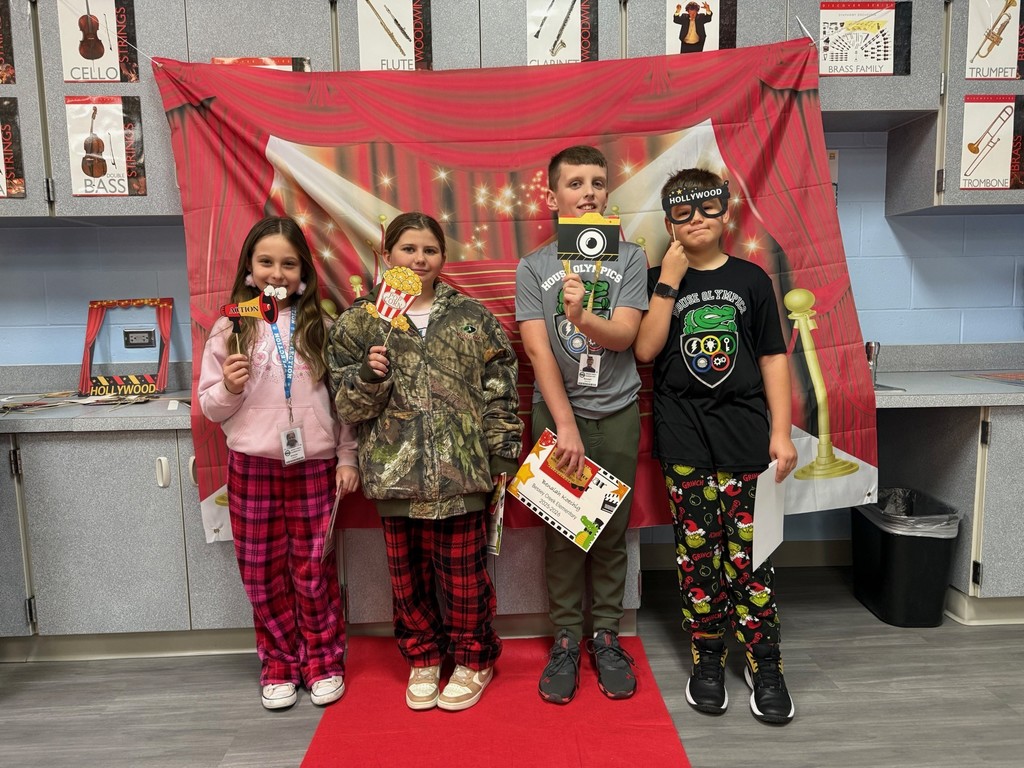 S.T.A.R. Gator Students pose in a room with a red carpet backdrop.