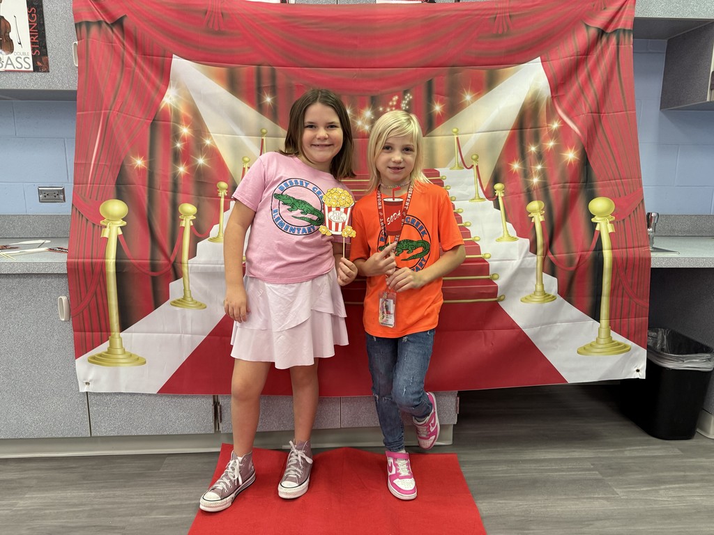 S.T.A.R. Gator Students pose in a room with a red carpet backdrop.