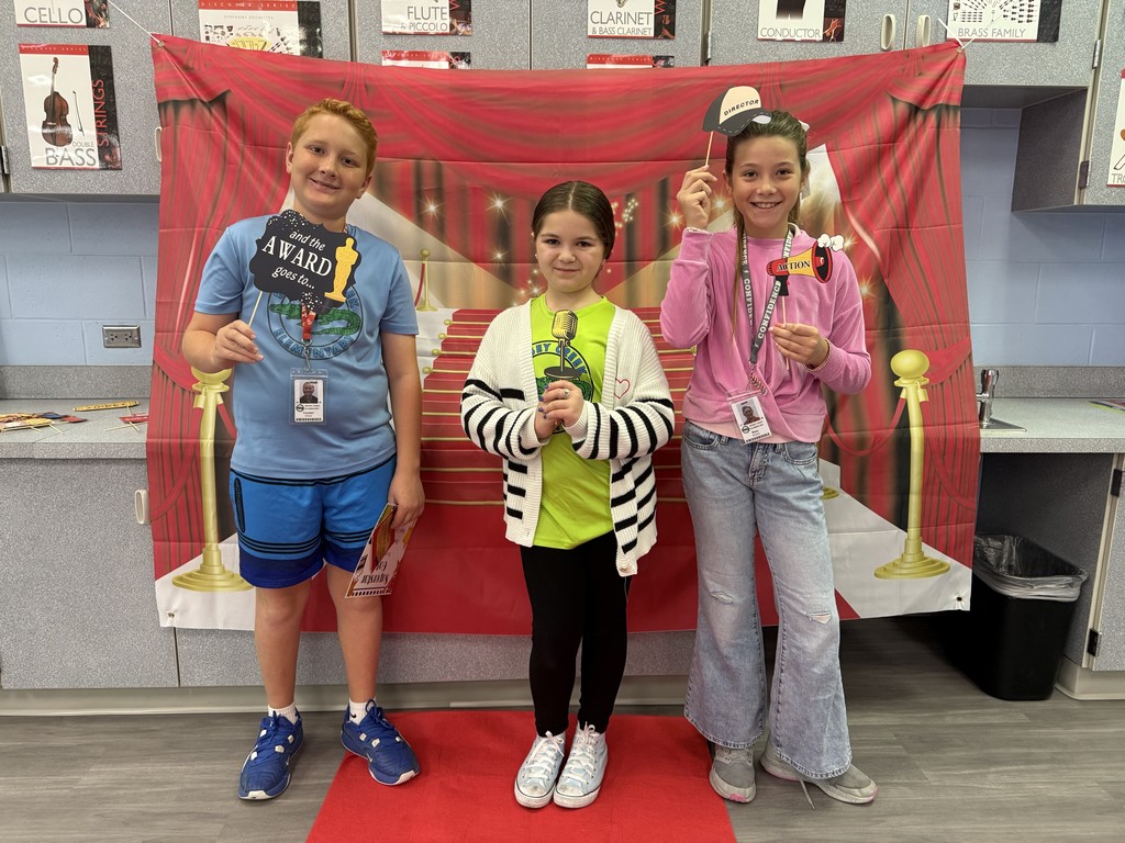S.T.A.R. Gator Students pose in a room with a red carpet backdrop.