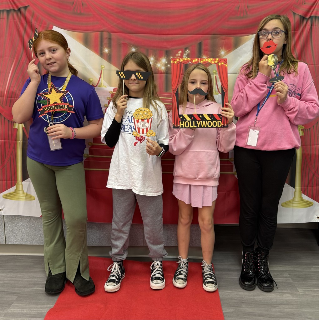 S.T.A.R. Gator Students pose in a room with a red carpet backdrop.