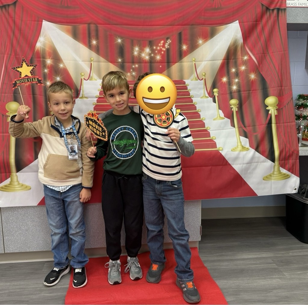 S.T.A.R. Gator Students pose in a room with a red carpet backdrop.