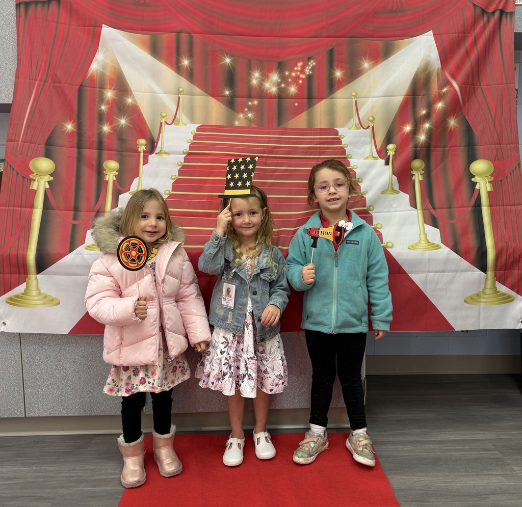 S.T.A.R. Gator Students pose in a room with a red carpet backdrop.