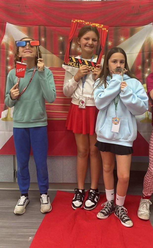 S.T.A.R. Gator Students pose in a room with a red carpet backdrop.