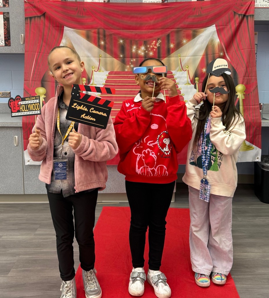 S.T.A.R. Gator Students pose in a room with a red carpet backdrop.