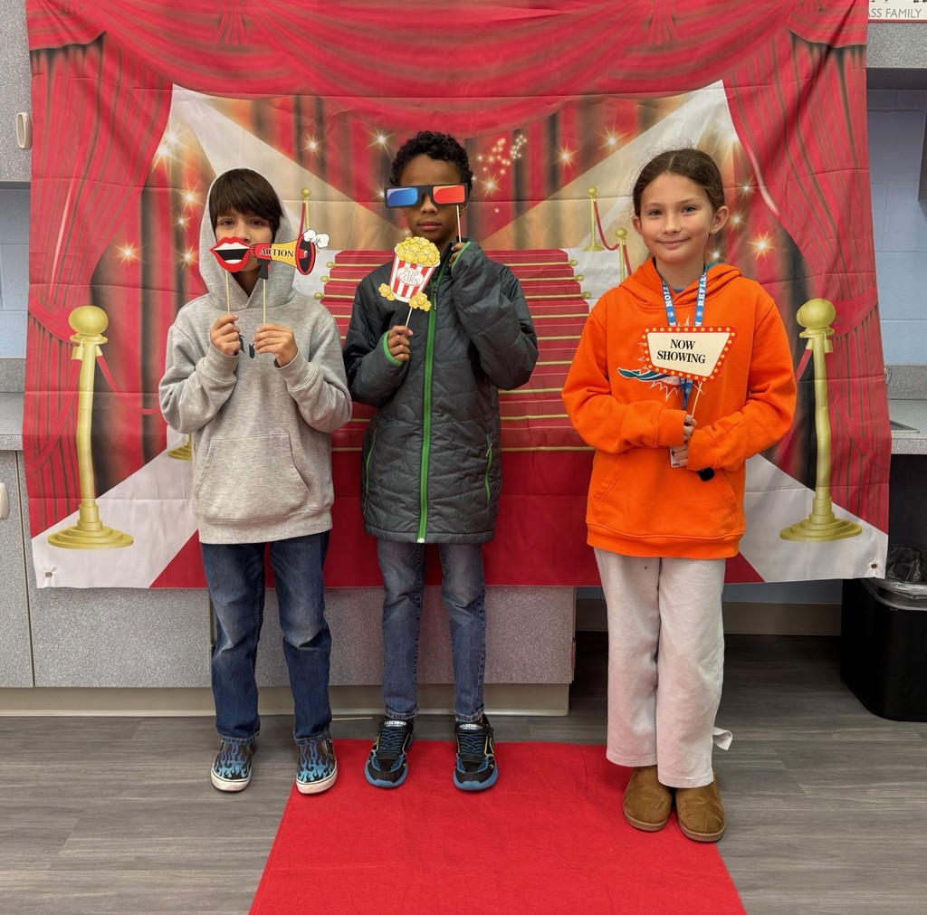 S.T.A.R. Gator Students pose in a room with a red carpet backdrop.