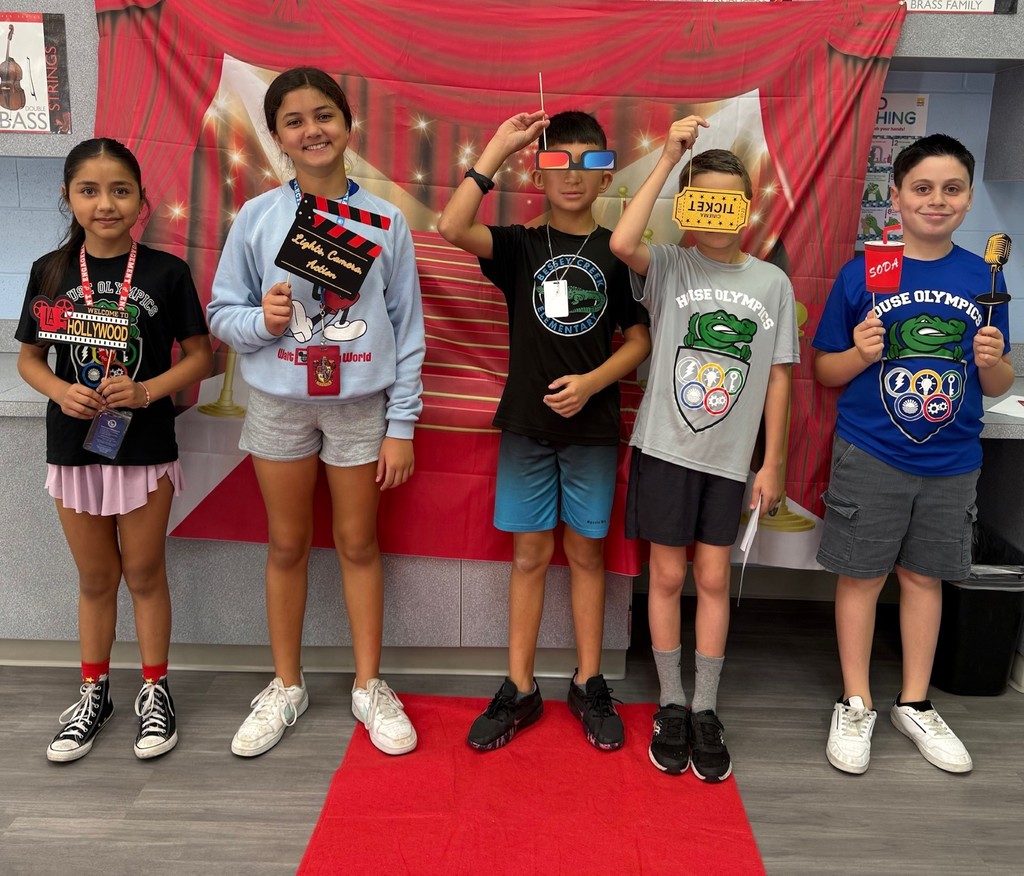 S.T.A.R. Gator Students pose in a room with a red carpet backdrop.