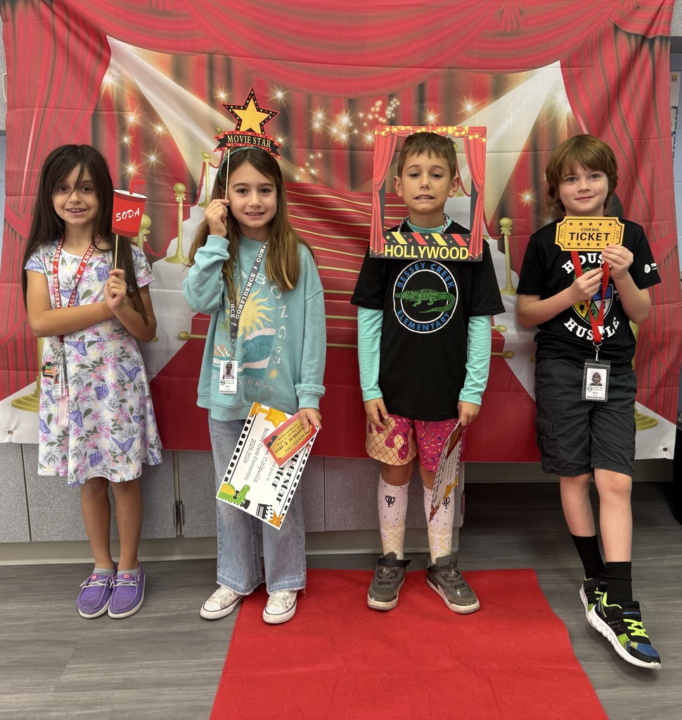 S.T.A.R. Gator Students pose in a room with a red carpet backdrop.