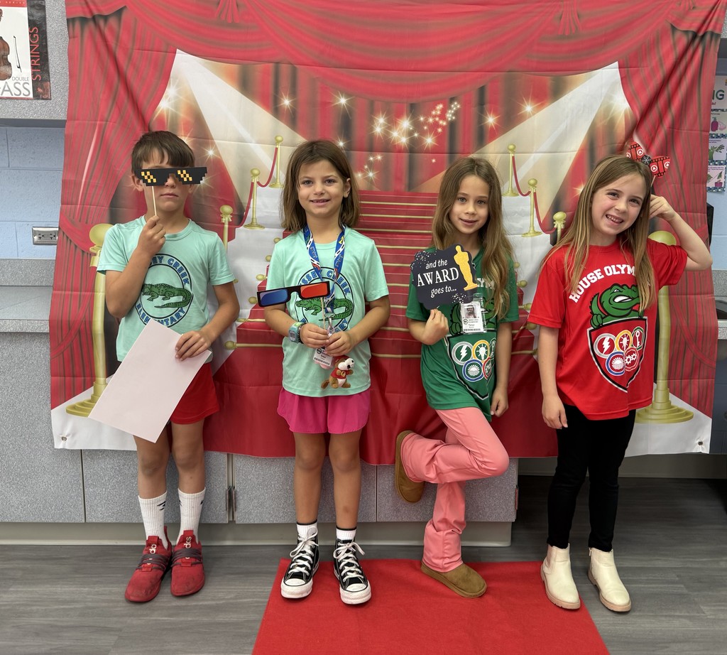 S.T.A.R. Gator Students pose in a room with a red carpet backdrop.