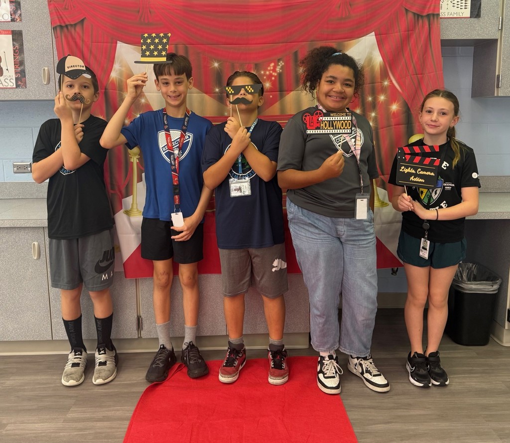 S.T.A.R. Gator Students pose in a room with a red carpet backdrop.