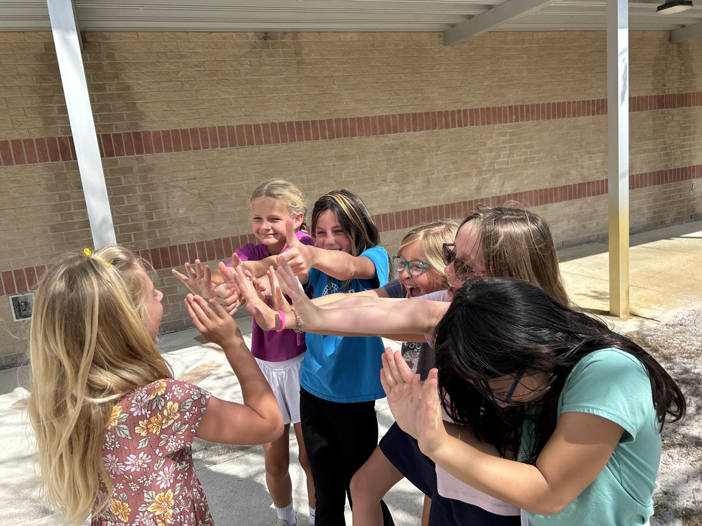 Kendall's friends high five her for winning the Wonderland Challenge.