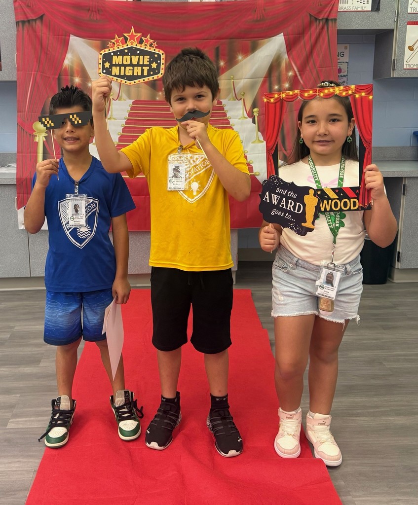 S.T.A.R. Gator Students pose in a room with a red carpet backdrop.