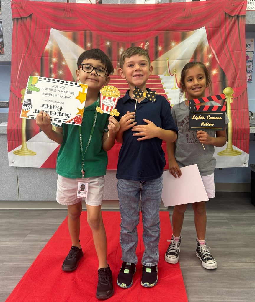 S.T.A.R. Gator Students pose in a room with a red carpet backdrop.