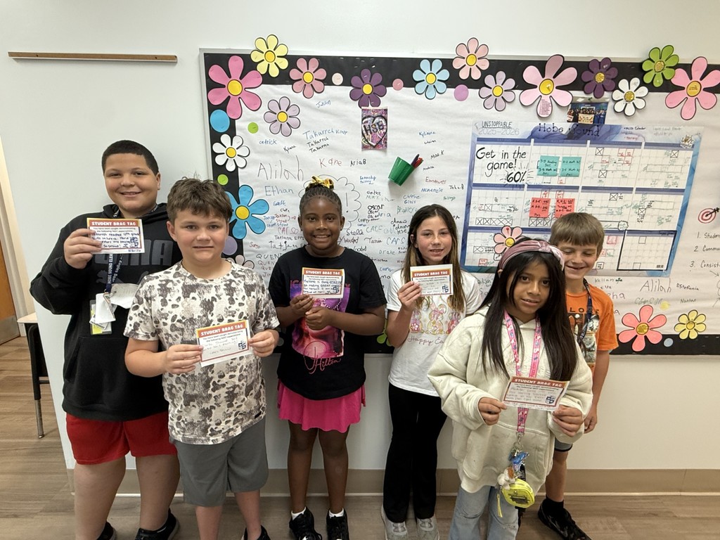 4th graders signing the office brag wall