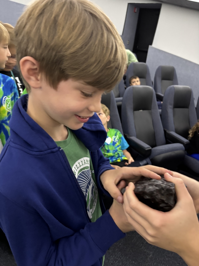 student holding meteorite 