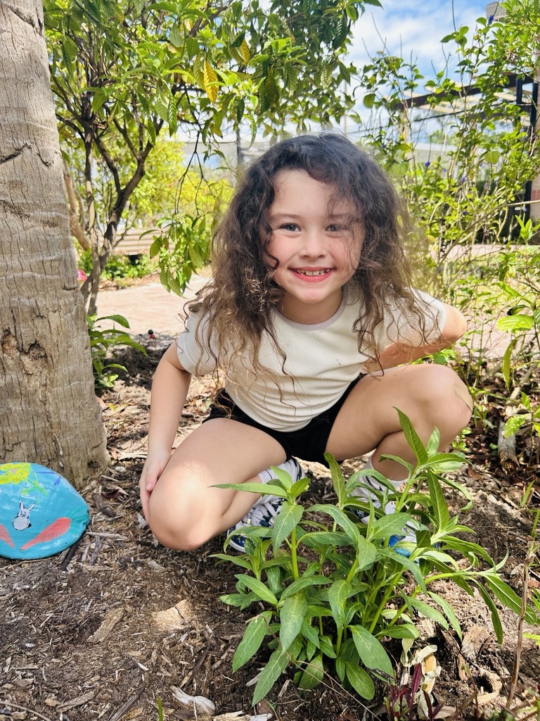 4H student at HSE planting milkweed in our garden