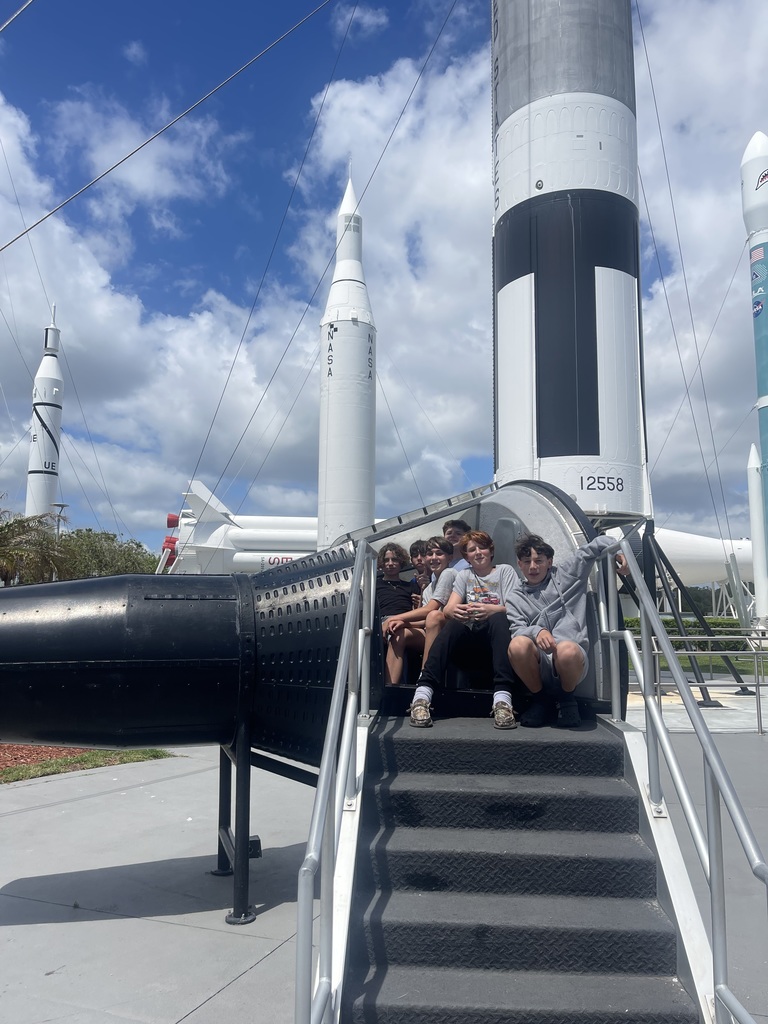8th grade boys posing near the rocket