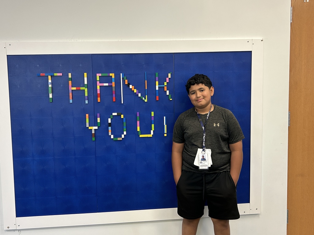 Boy next to lego board