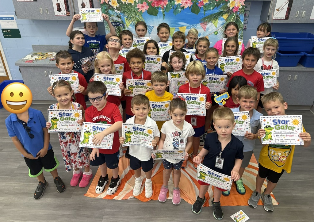 STAR Gators pose in front of a beach-themed backdrop.