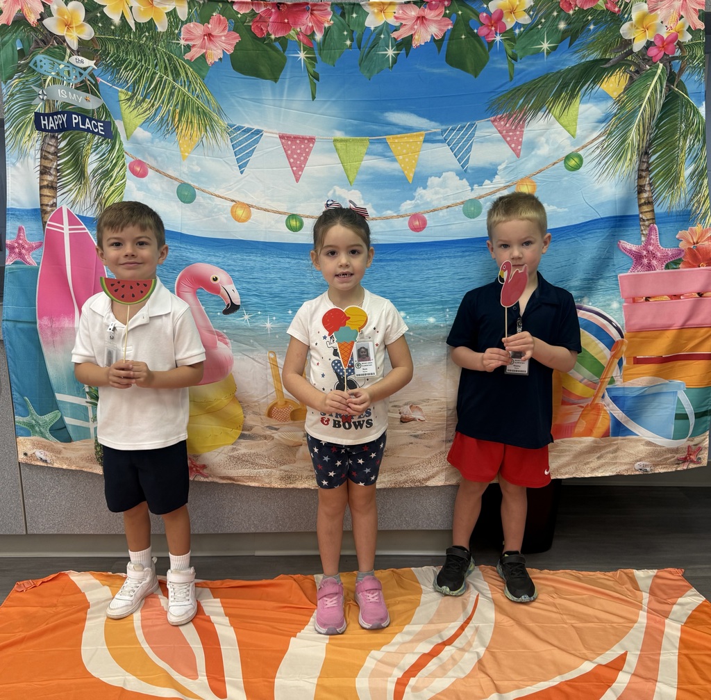 STAR Gators pose in front of a beach-themed backdrop.