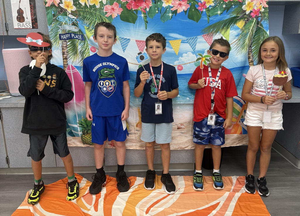 STAR Gators pose in front of a beach-themed backdrop.