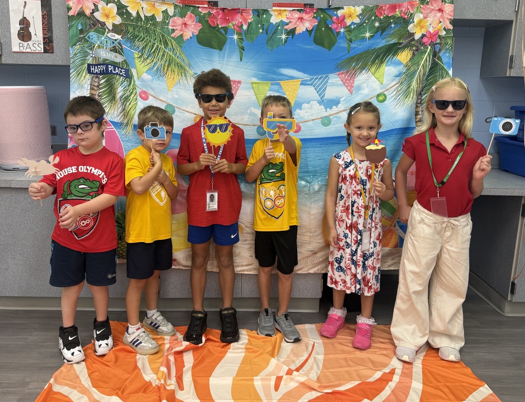 STAR Gators pose in front of a beach-themed backdrop.