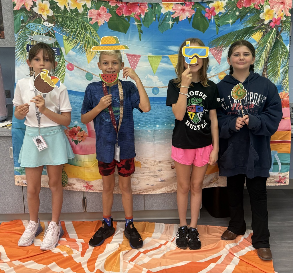STAR Gators pose in front of a beach-themed backdrop.