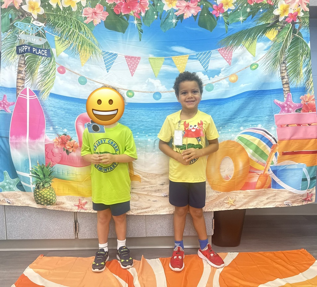STAR Gators pose in front of a beach-themed backdrop.