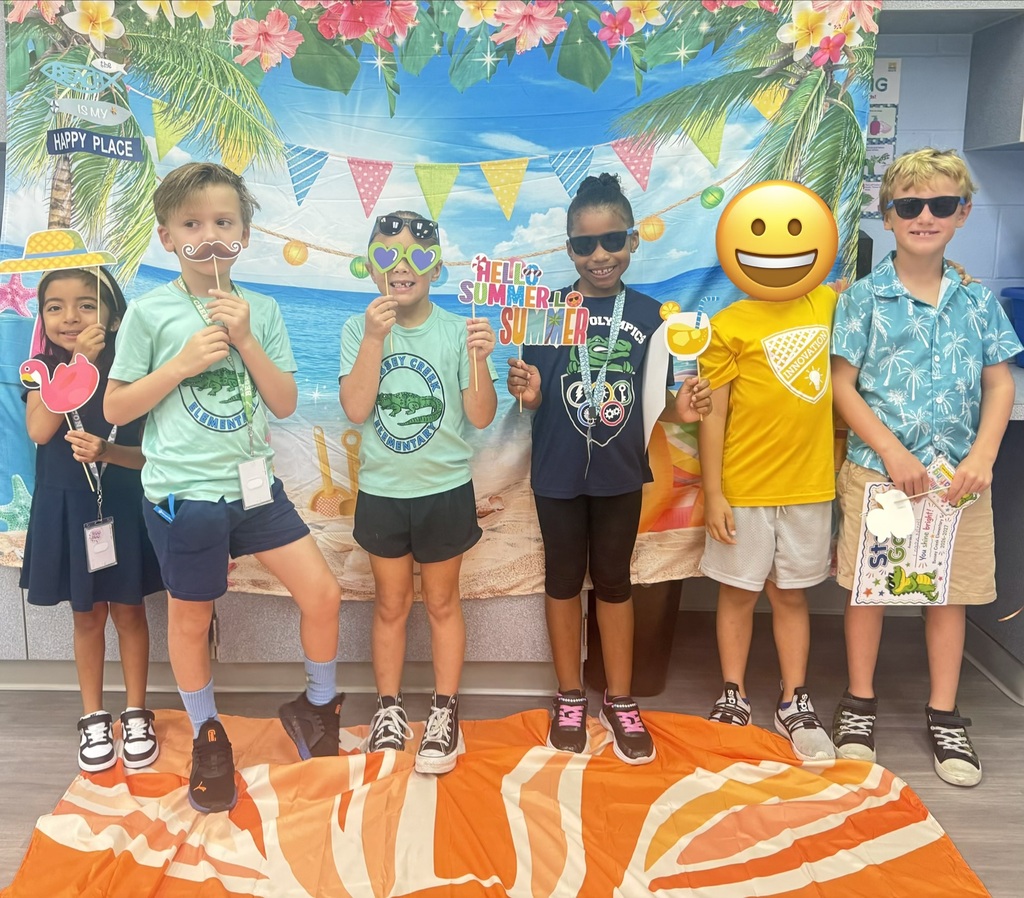 STAR Gators pose in front of a beach-themed backdrop.