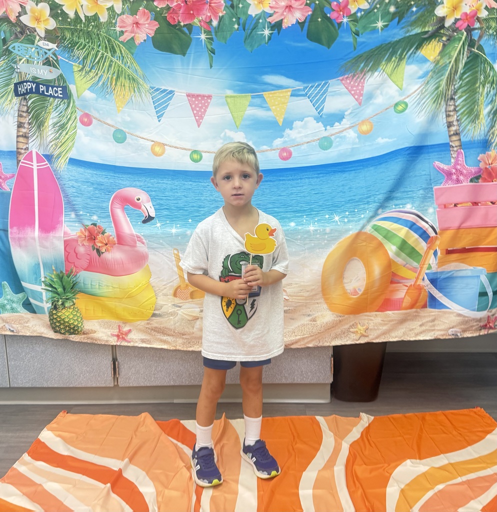 STAR Gators pose in front of a beach-themed backdrop.