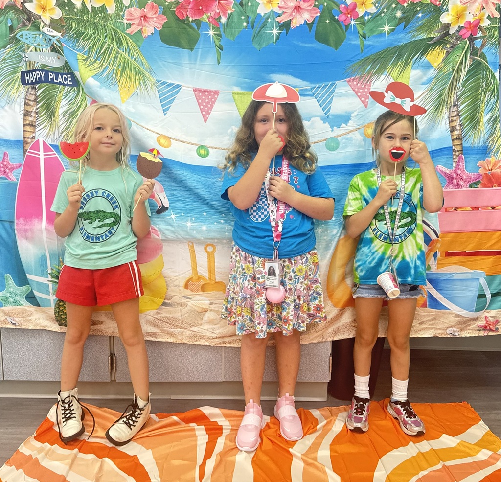 STAR Gators pose in front of a beach-themed backdrop.