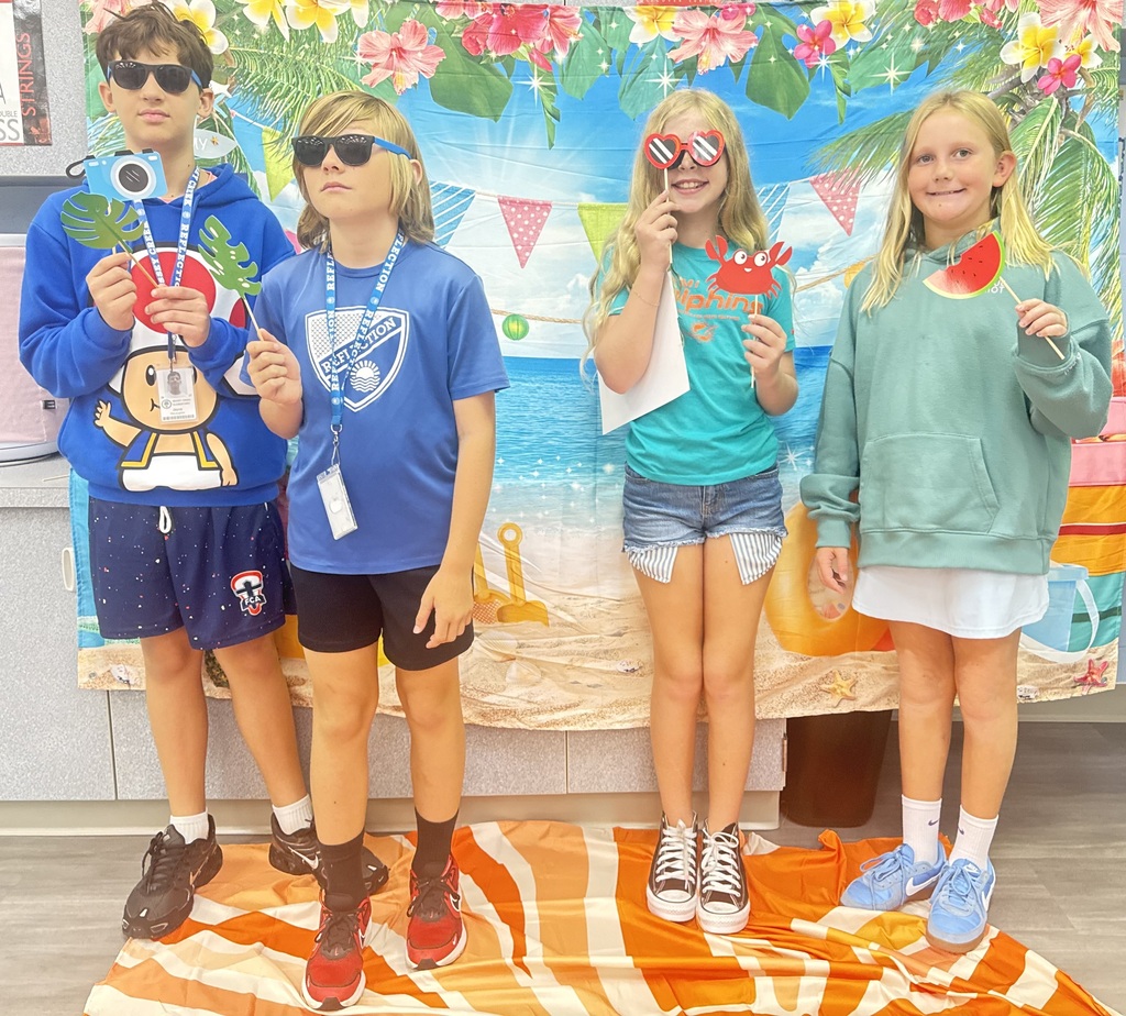 STAR Gators pose in front of a beach-themed backdrop.