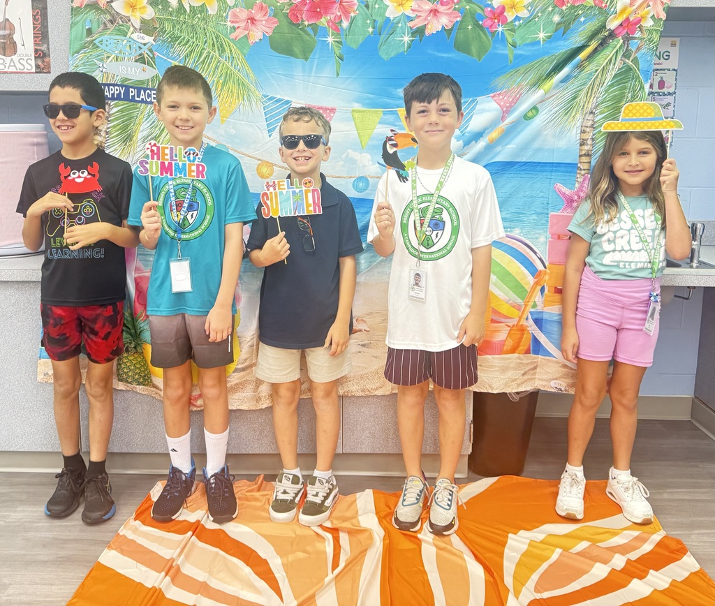 STAR Gators pose in front of a beach-themed backdrop.