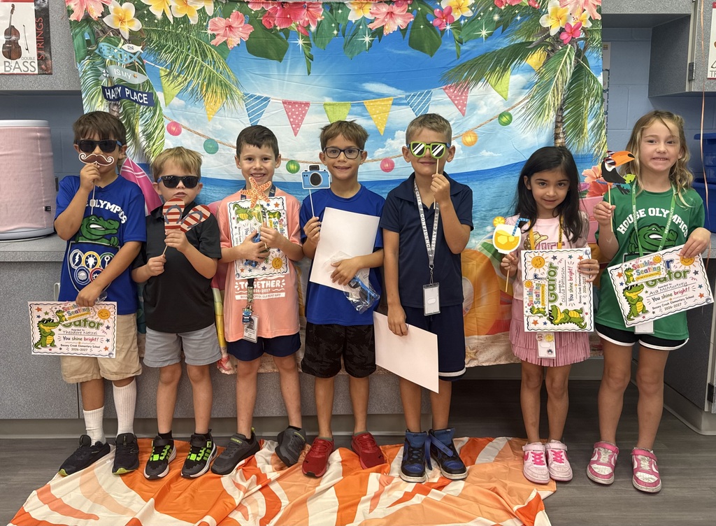 STAR Gators pose in front of a beach-themed backdrop.