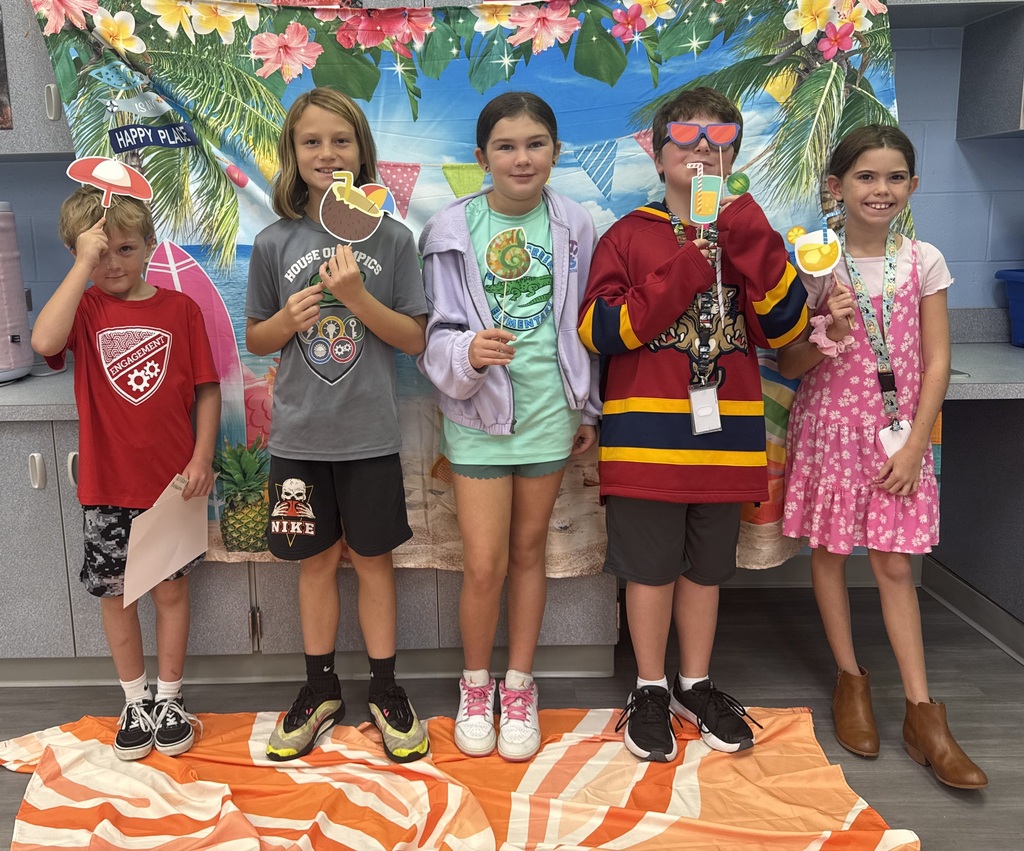 STAR Gators pose in front of a beach-themed backdrop.